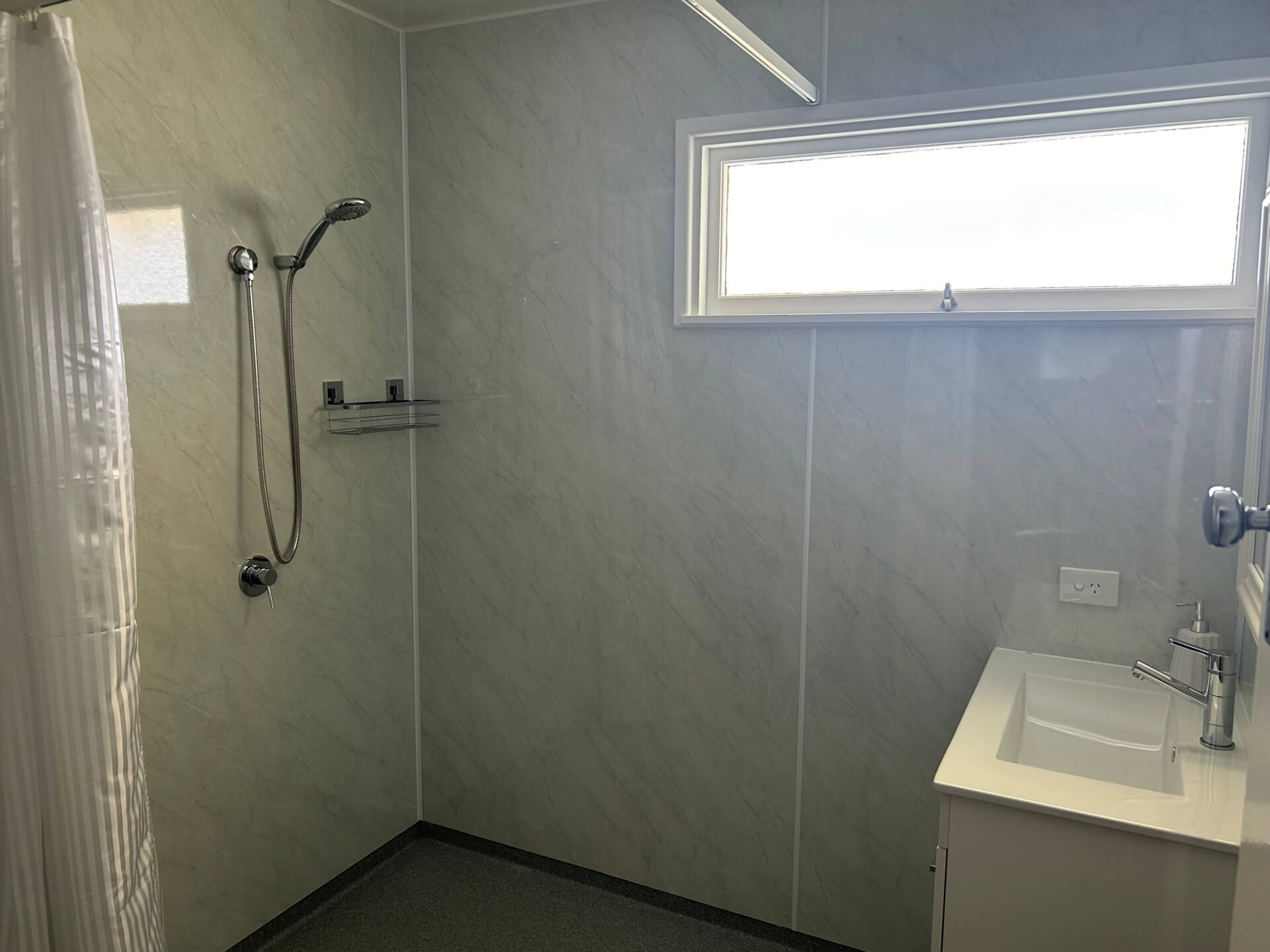 a bathroom with a sink and shower