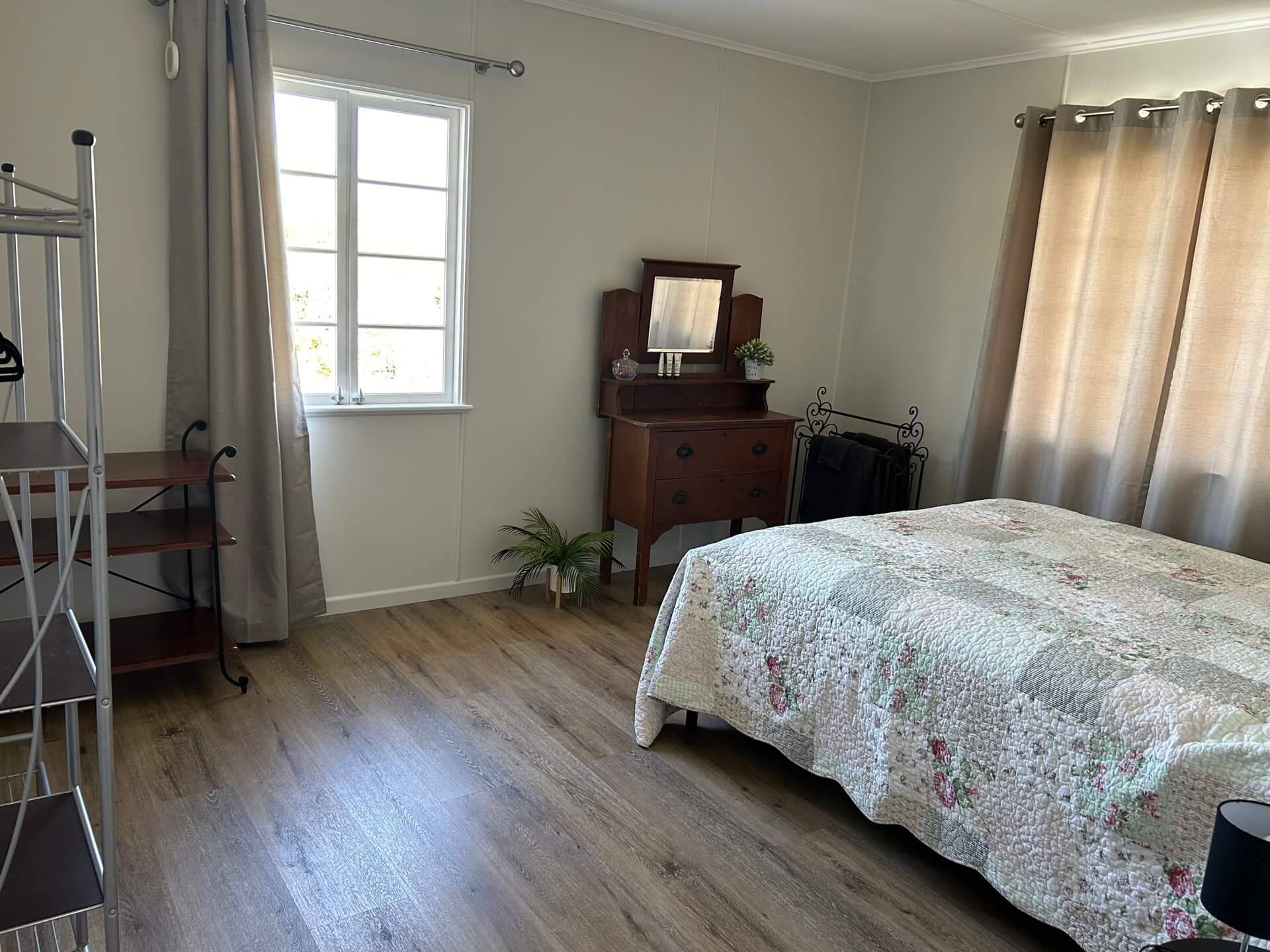 a bedroom with a wood floor and a bed