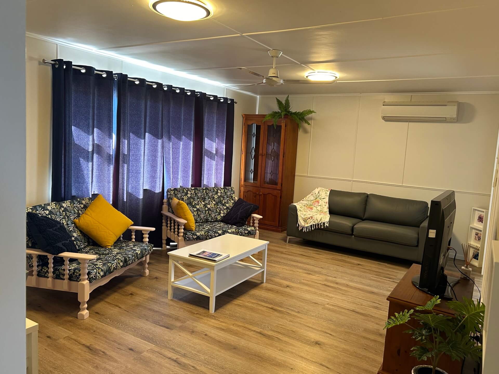 Royal Jasmyn House living room with couches and a tv
